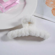 Close-up of a white sock with a small brown stain on a white background