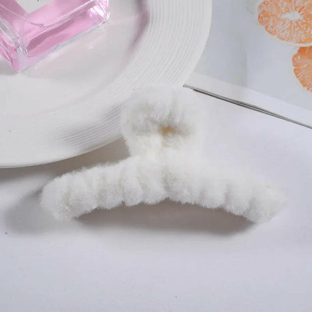 Close-up of a white sock with a small brown stain on a white background