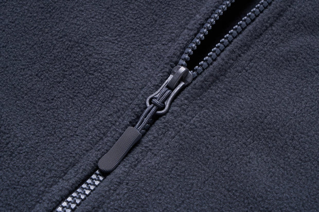 Close-up of a zipper on a dark fabric background