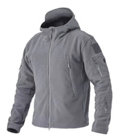 Gray tactical jacket with multiple zippers and patches on a white background