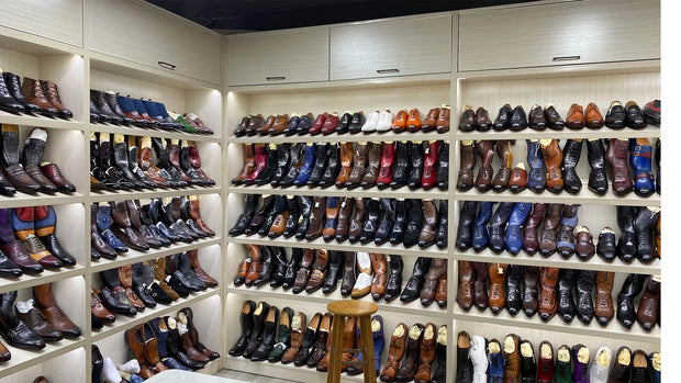 Shoe display with various boots on shelves in a store.
