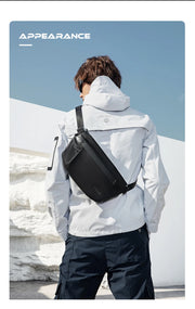 Person wearing a white jacket and black backpack with a snowy landscape in the background