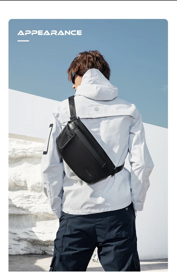 Person wearing a white jacket and black backpack with a snowy landscape in the background