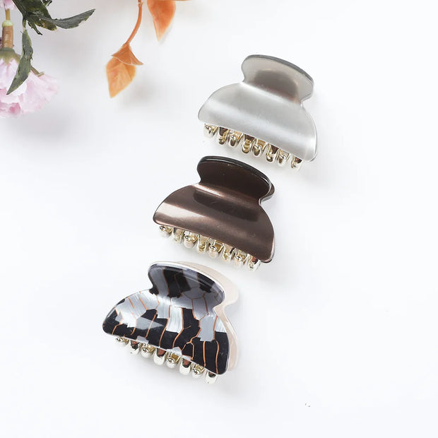 Set of three decorative hair clips on a white background
