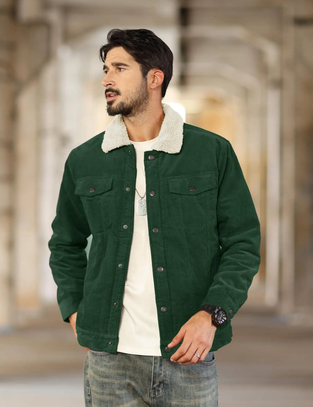 Man wearing a green jacket with a white collar in an indoor setting