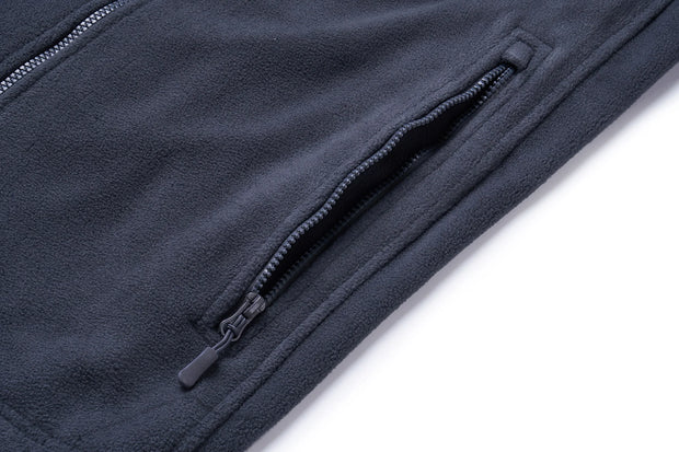 Close-up of a navy blue fleece jacket with a zipper on a white background