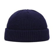 Navy blue knit beanie on a white background