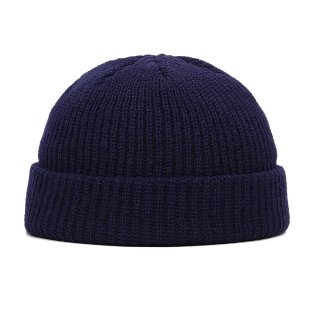 Navy blue knit beanie on a white background