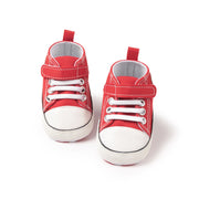 Red high-top sneakers with white soles on a white background
