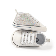 Pair of glittery high-top sneakers on a white background