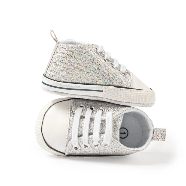 Pair of glittery high-top sneakers on a white background