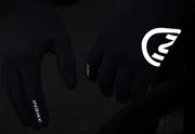 Black gloves with reflective design on a dark background