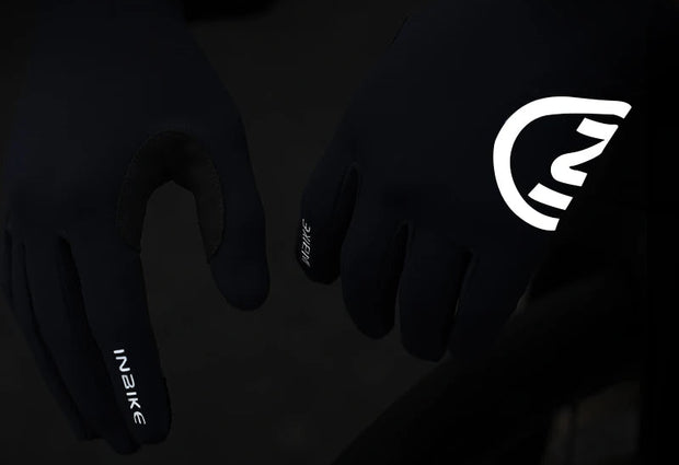 Black gloves with reflective design on a dark background