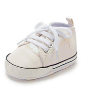 White baby shoe with laces on a white background