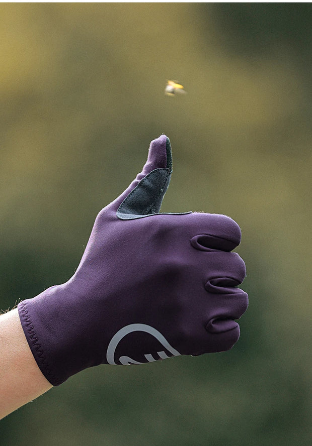 Purple glove on a blurred green background