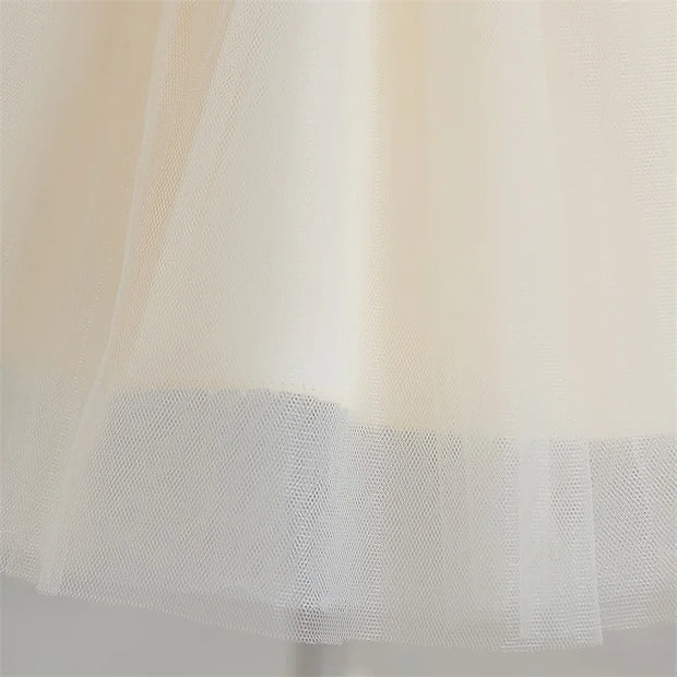 Close-up of a sheer fabric with a mesh pattern on a light background