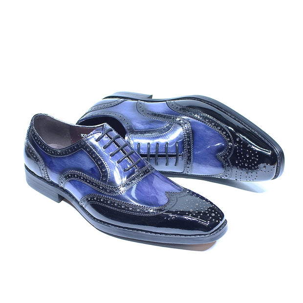 Pair of blue and black shiny dress shoes on a white background