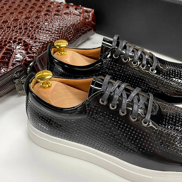 Black textured sneakers with gold buttons on a white surface