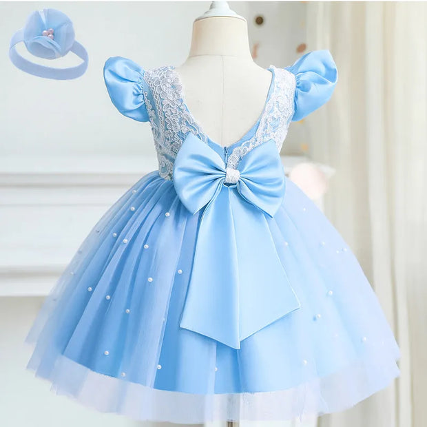 Light blue children's dress with a large bow on a mannequin against a white background