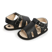 Pair of black children's sandals with buckles on a white background