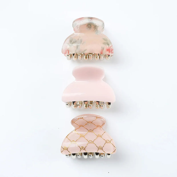 Pink and gold hair massager on a white background