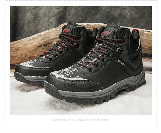 Black hiking boots with red laces on a snowy ground