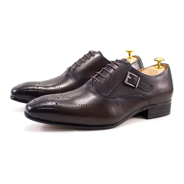 Pair of dark brown leather dress shoes with a gold buckle on a white background