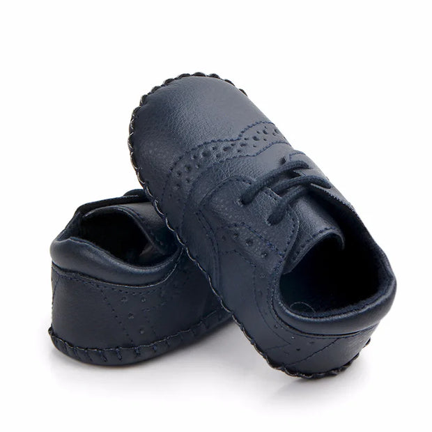 Pair of navy blue leather shoes on a white background