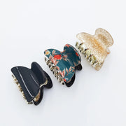 Three decorative hair clips on a white background