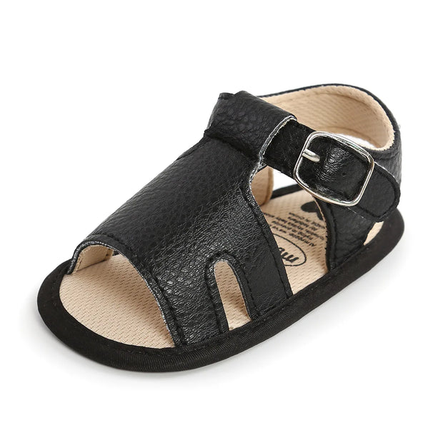 Black sandal with a buckle on a white background