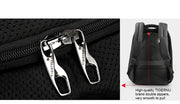 Close-up of a black backpack with double zippers and with a separate inset showing the zipper pull.