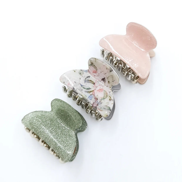 Three colorful hair clips on a white background
