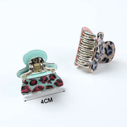 Two hair clips with leopard print design on a white background, one with a measurement label.