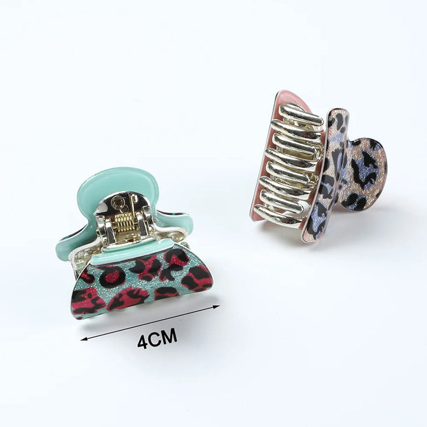 Two hair clips with leopard print design on a white background, one with a measurement label.