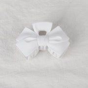 White bow-shaped object on a textured gray background