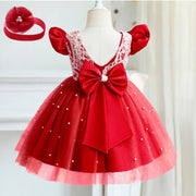 Red children's dress with a large bow and matching headband on a mannequin against a white background.