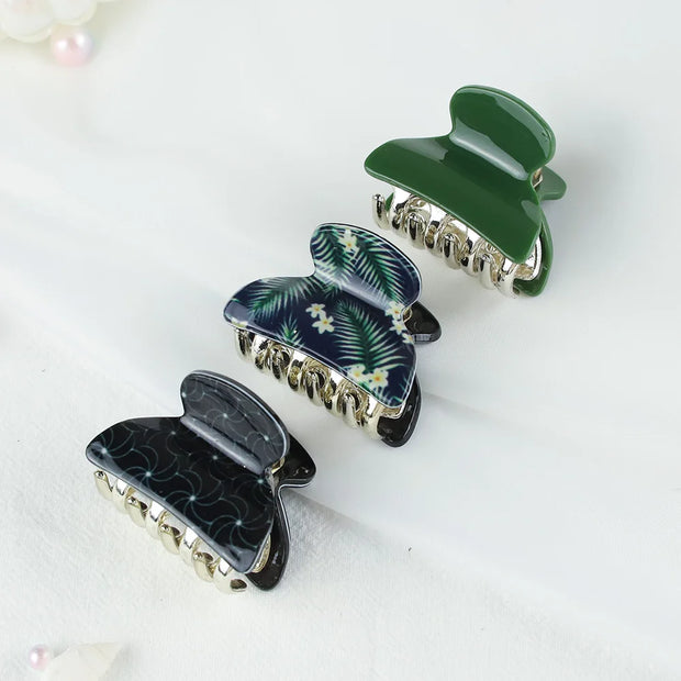Three decorative hair clips on a white background