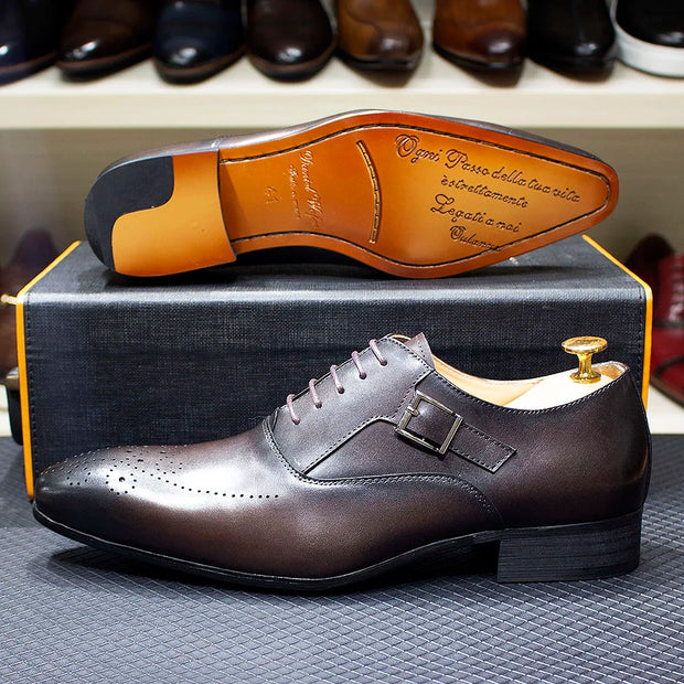 Brown leather dress shoe with gold buckle on a textured surface, brand name visible