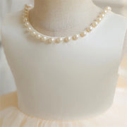 Pearl necklace on a mannequin bust with a soft focus background