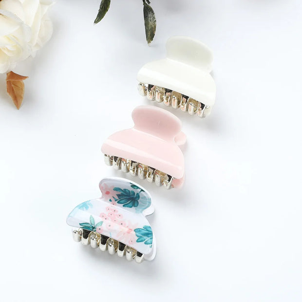 Set of three decorative hair clips on a white background