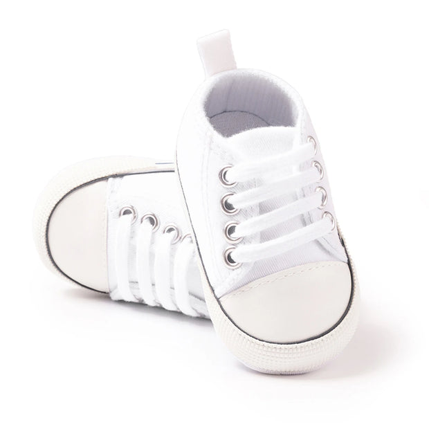 White high-top sneakers on a white background