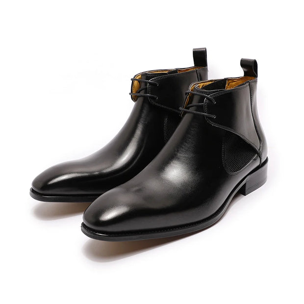 Pair of black leather boots on a white background