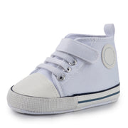 White baby shoe with a strap on a white background