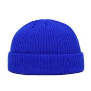 Blue knit beanie on a white background