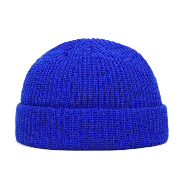 Blue knit beanie on a white background