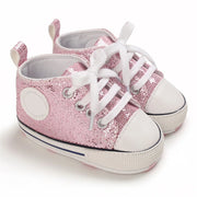 Pink sequin high-top sneakers with white laces on a white background
