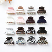 Collection of variously designed hair clamps on a white background