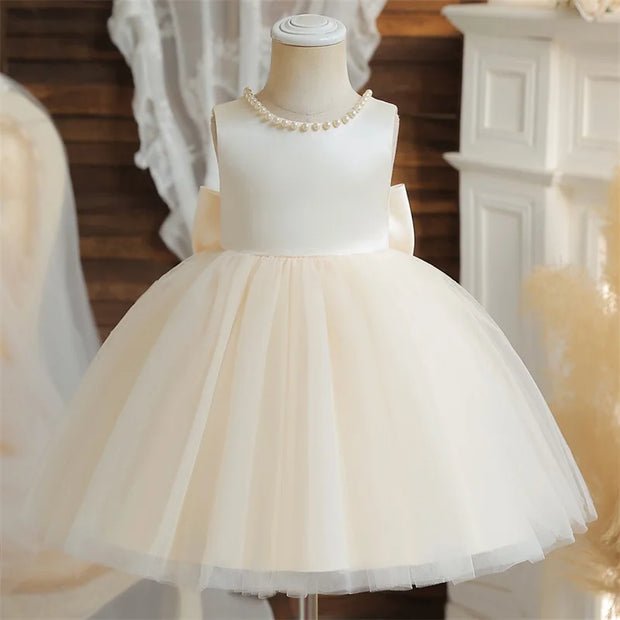 White and beige dress on a mannequin with a blurred background