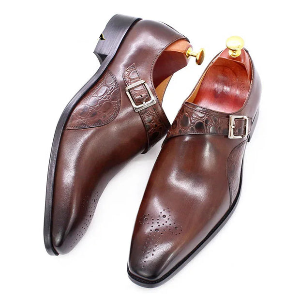 Brown leather dress shoes with buckle detail on a white background