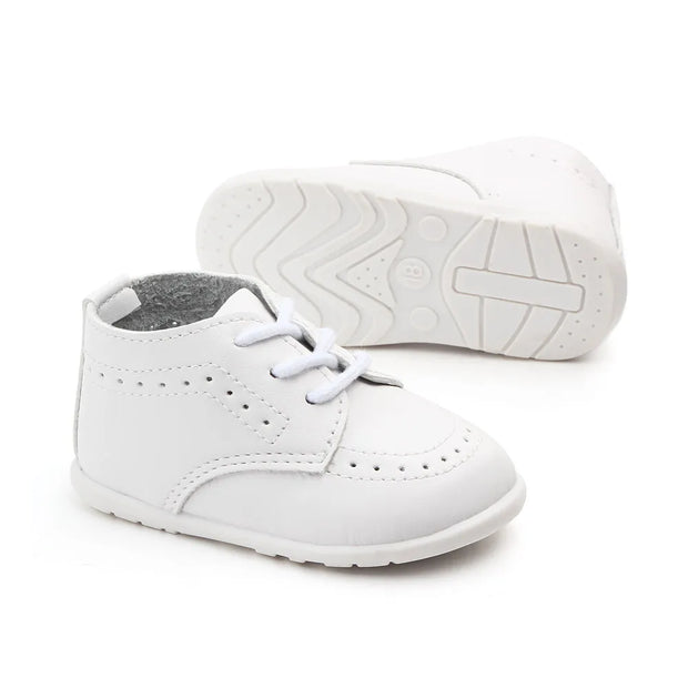 White baby shoes with laces on a white background